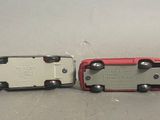 two toy cars sitting next to each other on a table