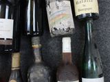 many bottles of wine that are sitting on the floor