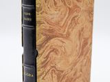 un livre à la couverture noire posé sur une table blanche