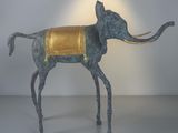 statue of an elephant with a gold cloth on its back