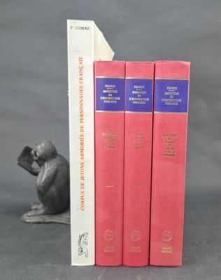 three bookends in the shape of a mouse and a book