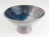 a blue and white bowl sitting on a white surface