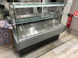 a glass display case in the middle of a store