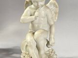 statue of a boy with a bird on his shoulder