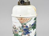an image of a white and blue vase with a bird on it