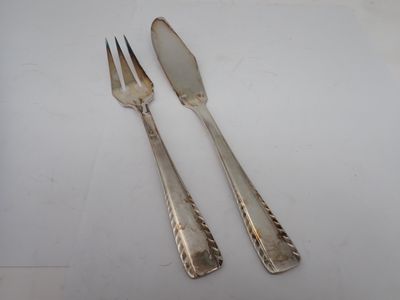 pair of silver plated forks and spoons on a white surface