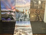 three canvass of different sizes and colors are sitting on a table