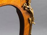 an antique wooden table with a marble top and gold decoration