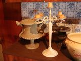 two vases and a candle on a shelf in a room