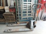 a stack of pallets and a forklift in a garage