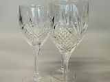 two empty wine glasses sitting on a table