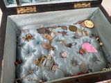 a suitcase with a bunch of jewelry inside of it