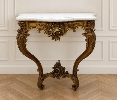 a marble top table in a room with white walls