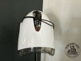 a white toaster on a stand with a black handle