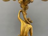 an antique gold candelabra with a bird on top of it