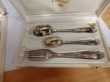 a box with silverware inside of it on a table