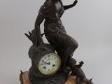 a statue of a woman sitting on top of a clock