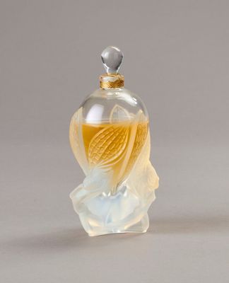 a small glass bottle with a bird inside of it