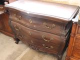 a brown dresser with a white top and gold handles