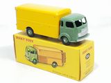 yellow and green toy truck sitting on top of a yellow box