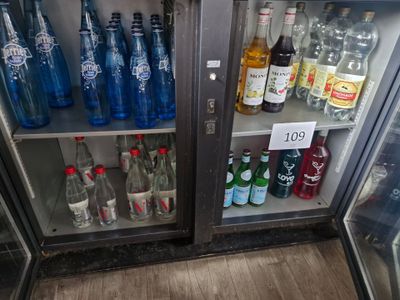 many bottles of soda and water in the refrigerator