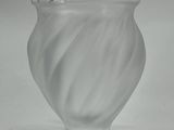 a glass vase that is sitting on a table