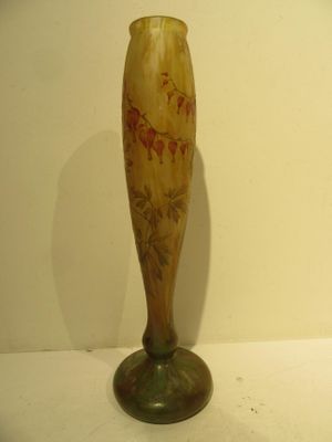 a vase with a flower in it sitting on a table