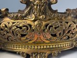 a large ornate brass bowl with a lion head on it
