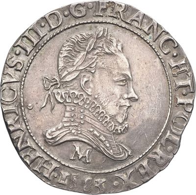 Gros plan sur une pièce de monnaie portant le visage d'un homme