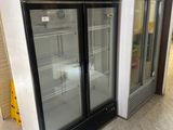 two refrigerators that are sitting in the middle of a room
