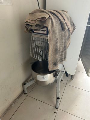 a laundry basket with a towel on top of it in the corner of a room