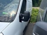 a white van parked next to another van in a parking lot
