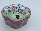 a small bowl with a painting on it sitting on a table