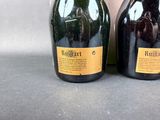 two bottles of wine sitting next to each other on a table