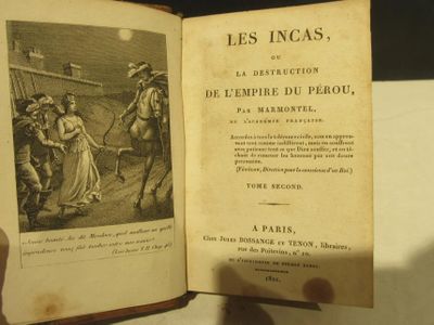 someone is holding an open book with a picture of a man on horseback