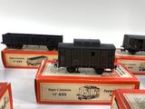 six train cars sitting on top of each other on a table