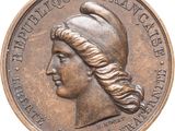 une vieille pièce de bronze sur laquelle figure la tête d'une femme