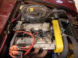 a red car with a yellow engine in the trunk