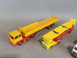 three toy trucks are lined up next to each other on a table