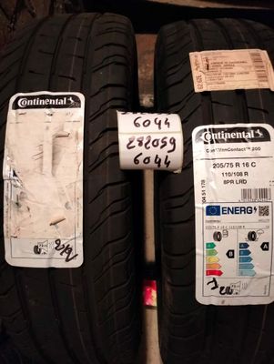 two tires with stickers on them are on display in a store