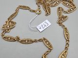 a close up of a gold chain with a tag on it