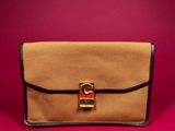 a brown and black purse sitting on top of a red surface