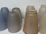 several vases are lined up in a row on a white surface
