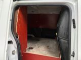a white van with a red door and a black seat