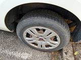 a white car with a flat tire on the street