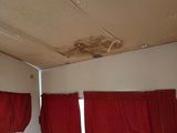 a picture of a room with red curtains and a hard wood floor