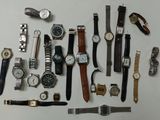 a lot of watches that are laying out on the table