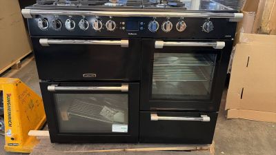 a black stove with two ovens in the middle of it