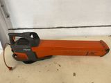 an orange and black electric blower sitting on top of a table