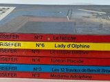 five books stacked on top of each other on a table